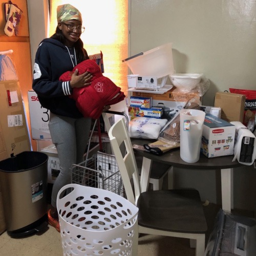 Woman with new belongings in her apartment.