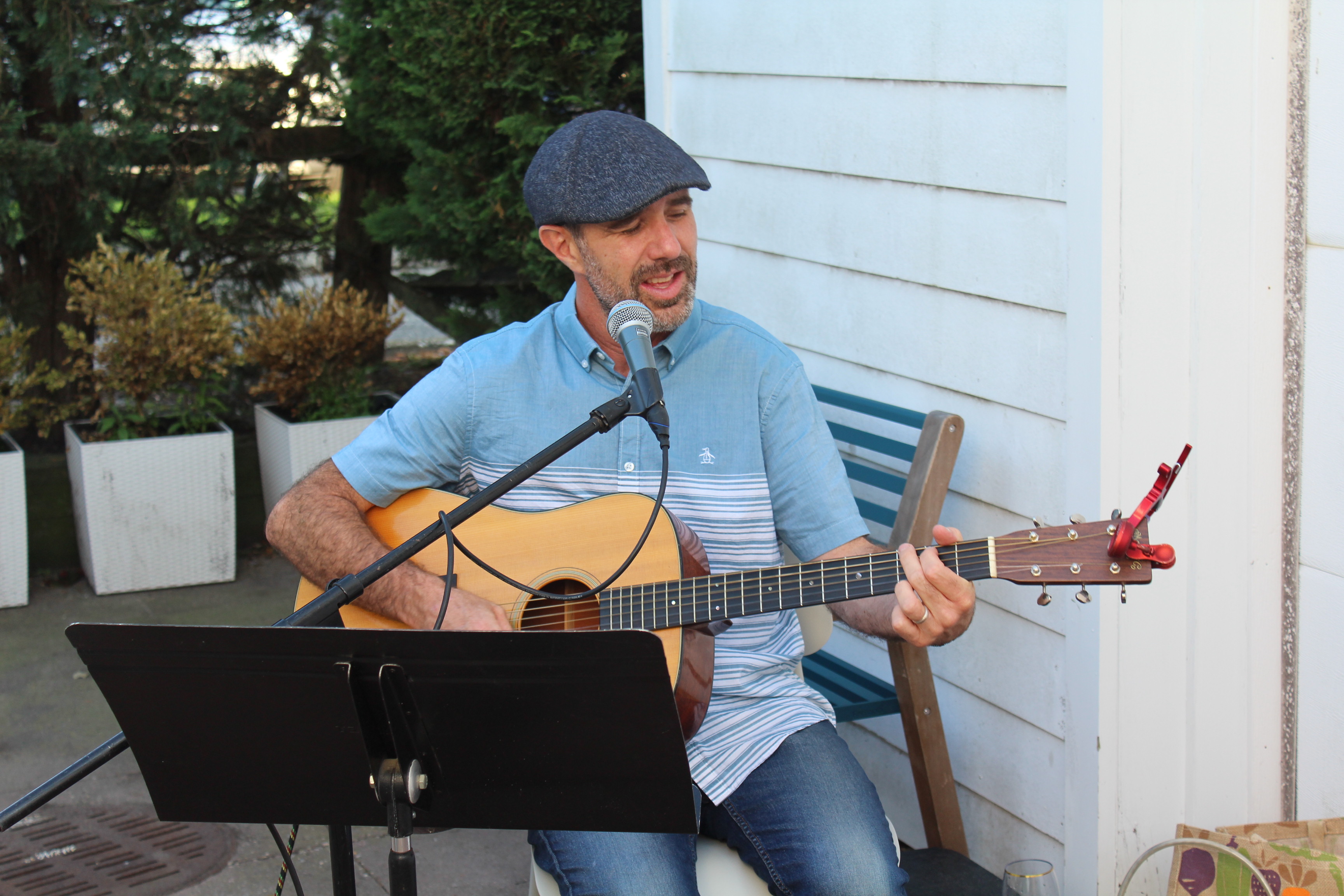 man singing playing guitar