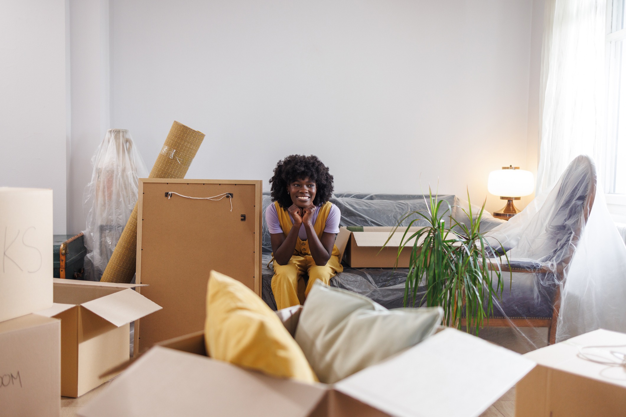 The joy of creating a well-ordered living space - African American woman in her new apartment